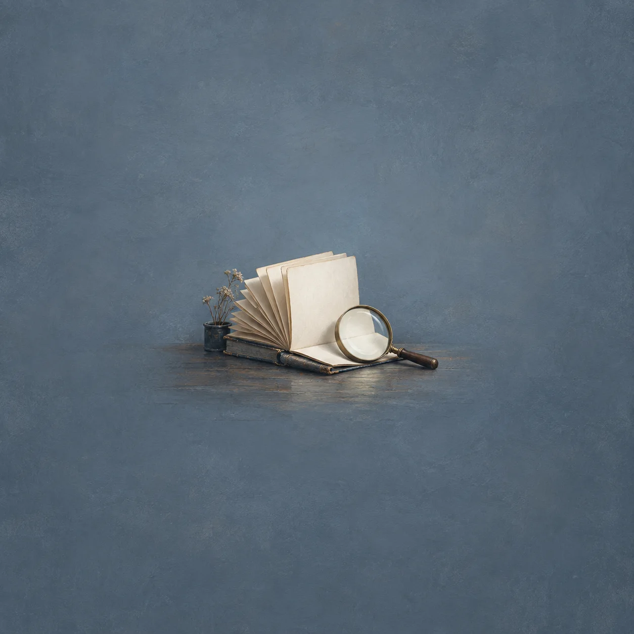 Painterly open blank ledger beside a magnifying glass on a blue-grey surface.