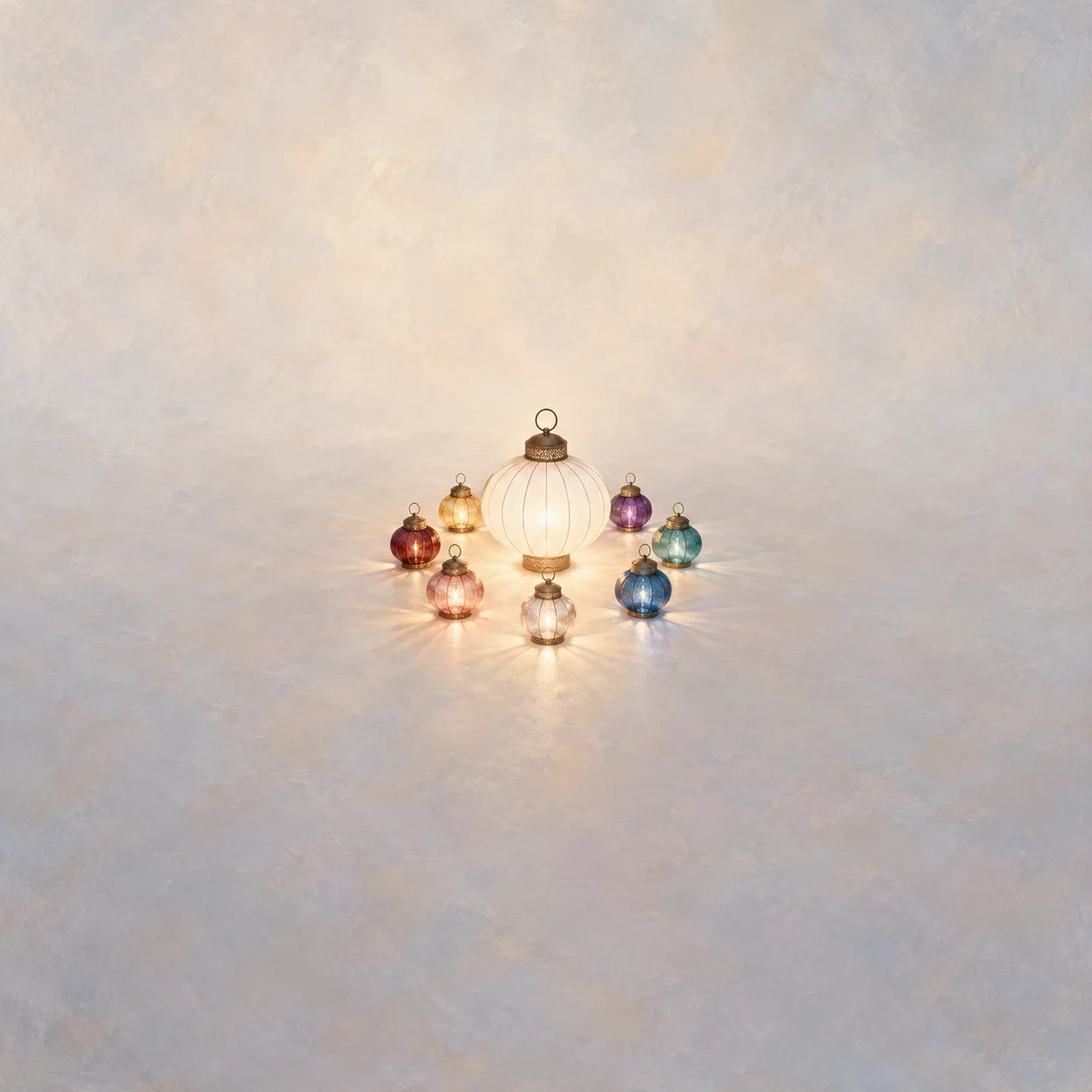 A large white lantern encircled by small glass lanterns in different jewel colors on a pale background.