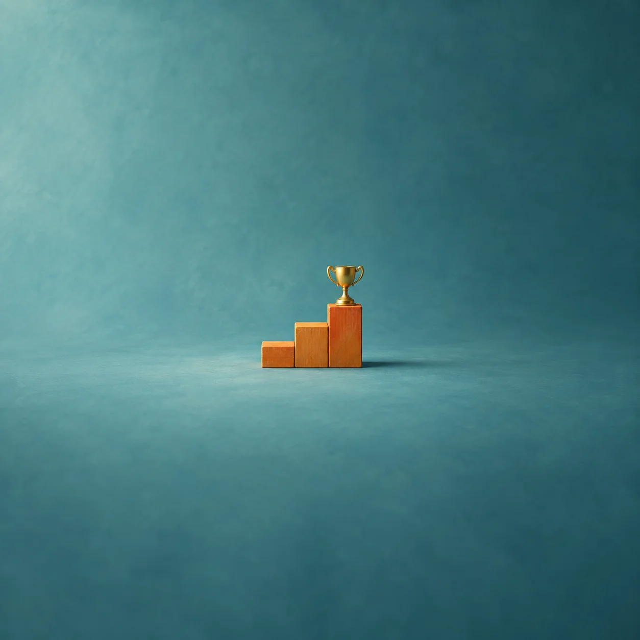 A small orange block staircase with a tiny gold trophy on the top step against a teal background.