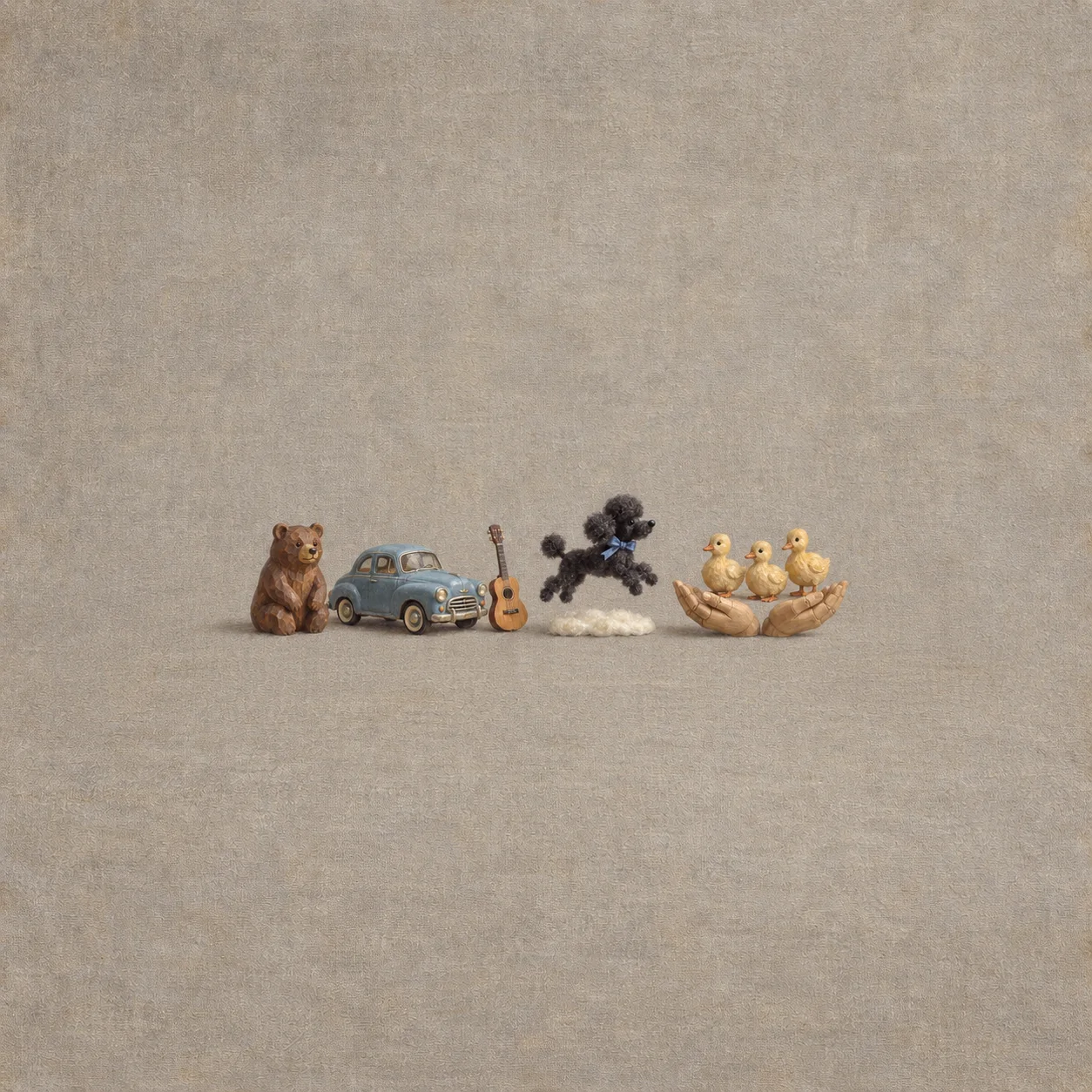 A wooden bear, blue vintage car and guitar sit beside a black felt poodle leaping above felt snow and three wooden goslings on cupped wooden hands.