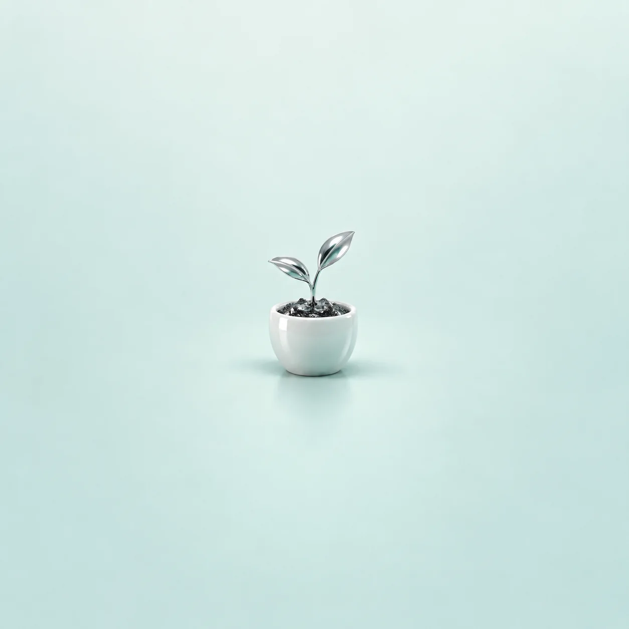 A shiny silver sprout growing from dark pebbles in a white ceramic pot against a mint background.