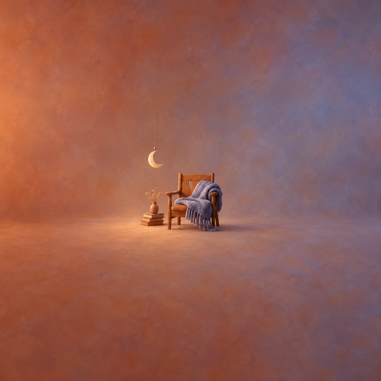 A small wooden armchair draped with a purple knitted blanket sits beside stacked books beneath a hanging crescent moon.