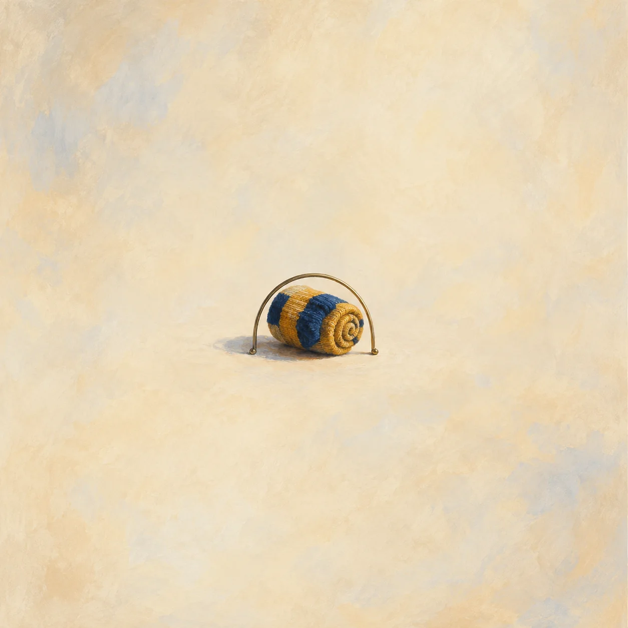 Rolled honey-and-navy striped sock inside a low bent-wire hoop
