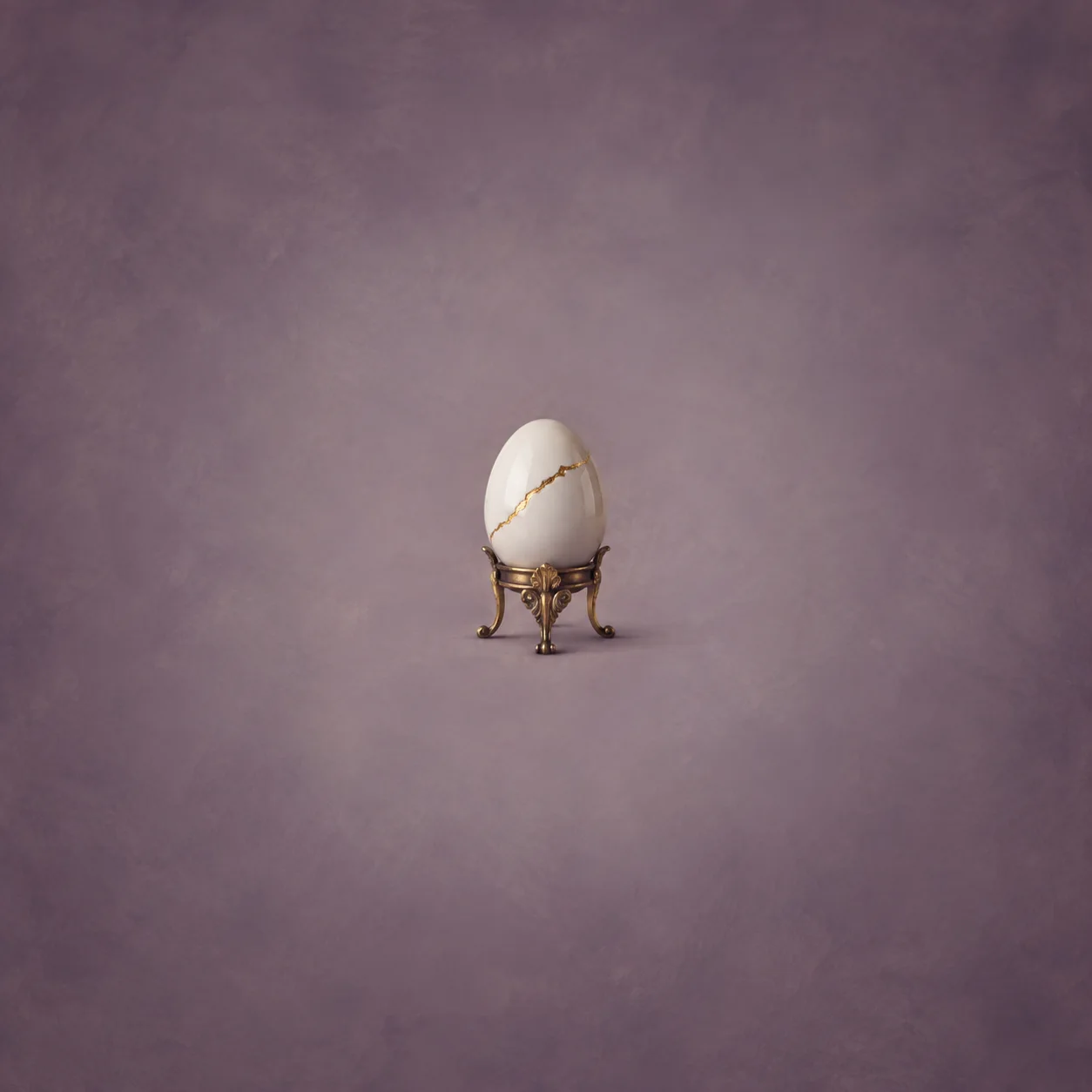 A white egg with a gold-filled crack resting in an ornate brass stand against a muted plum background.