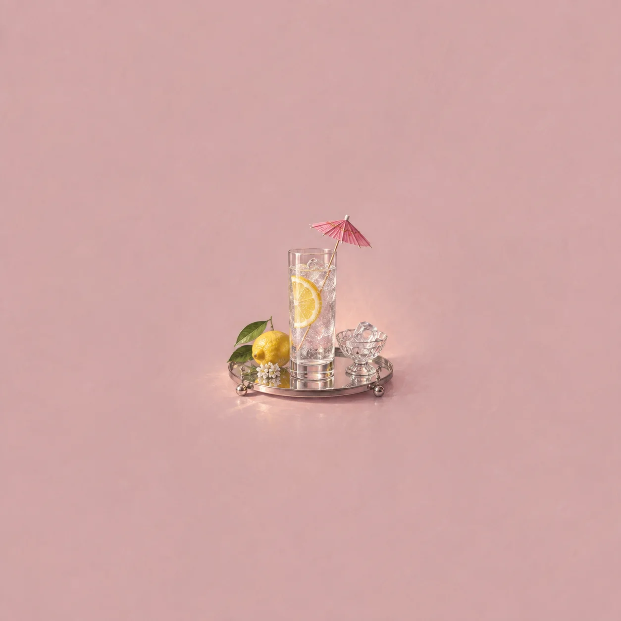 A tall glass with a lemon slice and pink paper umbrella on a mirrored tray.
