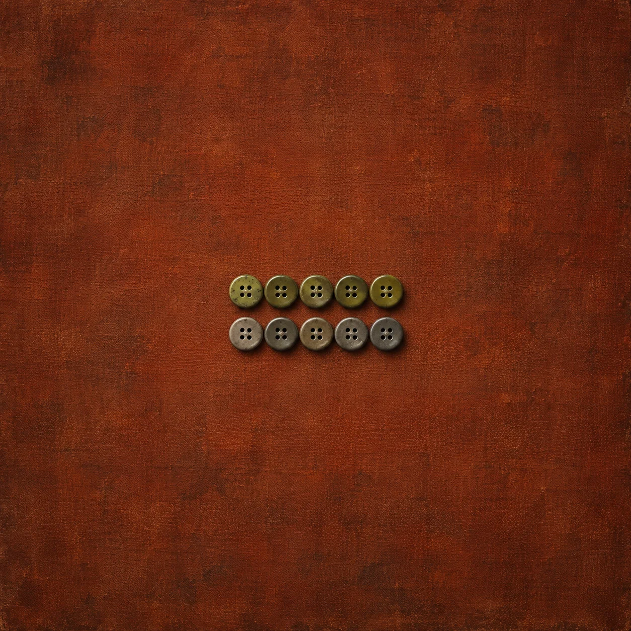 Two rows of buttons, olive green above and grey below, lie on rust-coloured cloth.