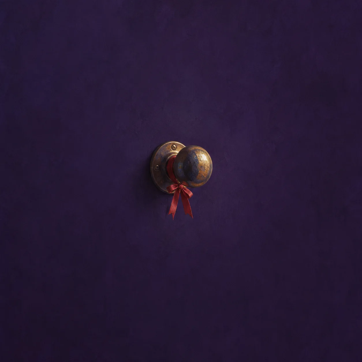 A worn brass doorknob with a red ribbon against a deep violet background.