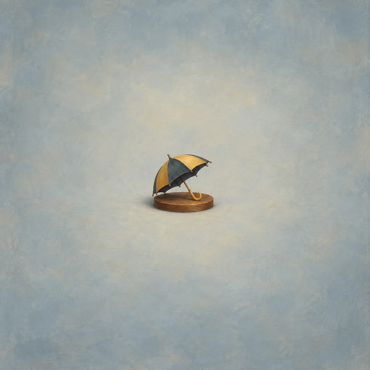 Open slate-and-yellow umbrella resting on a flat wooden base