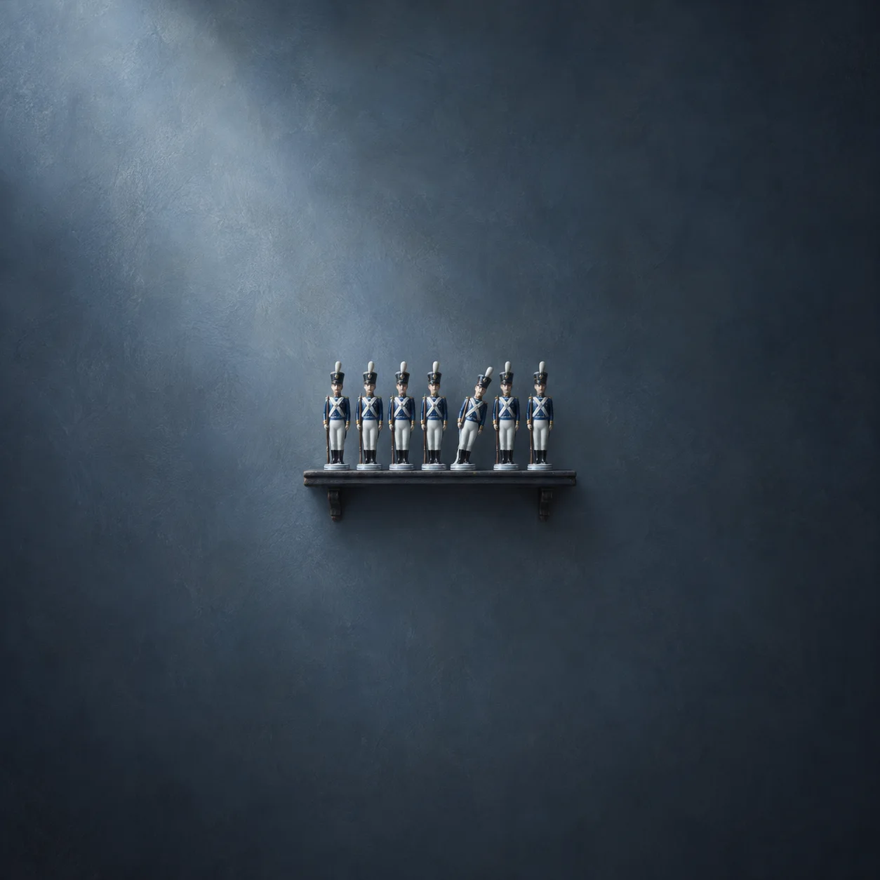 Painterly row of blue-and-white toy soldiers standing on a dark shelf.