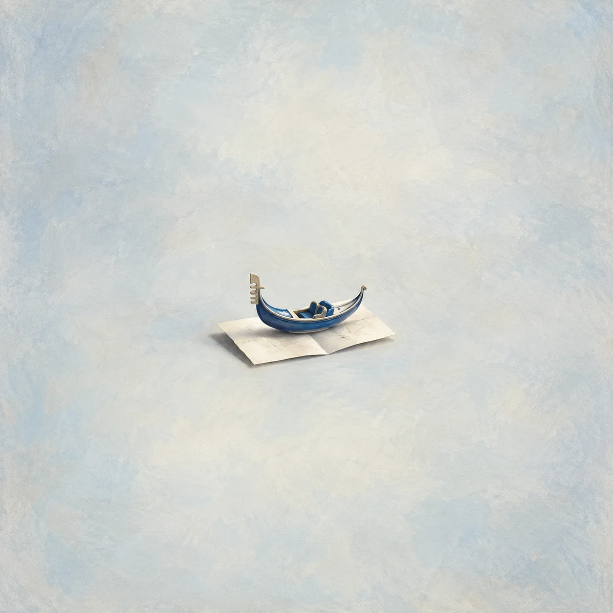 Small blue ceramic gondola with visible gold detail on a blank folded sheet