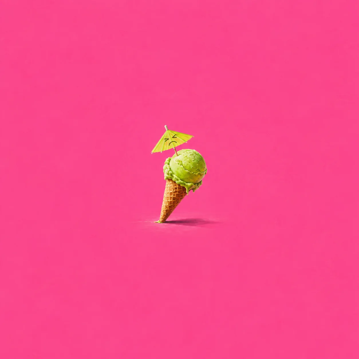 A lime-green ice-cream cone tilts beneath a tiny yellow paper umbrella against vivid pink.