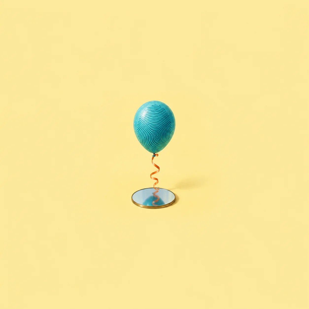 A turquoise balloon with a fingerprint-like pattern floats above a round mirror on a curled orange ribbon against yellow.