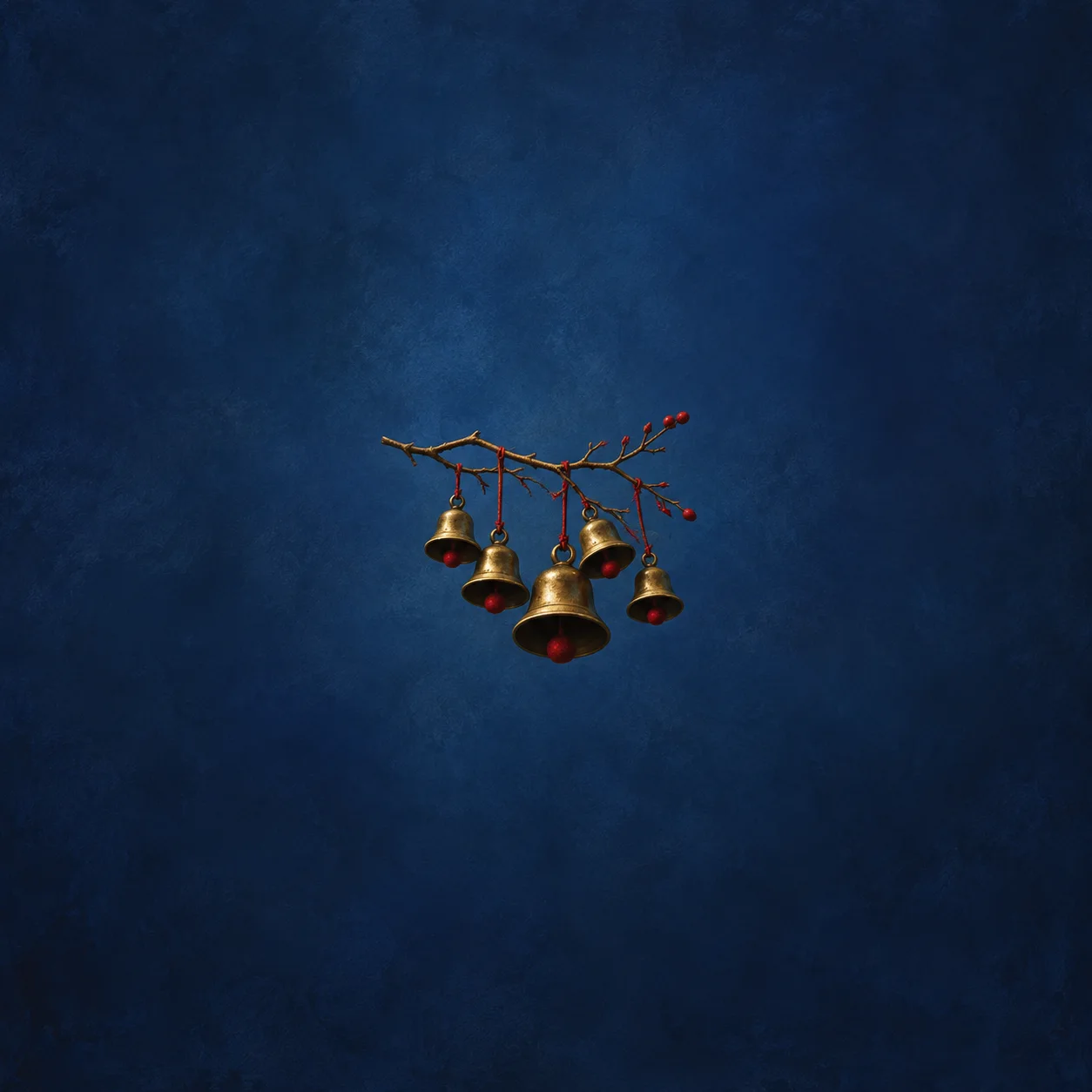 Brass bells with red clappers hang from a thin berry-bearing branch against deep blue.