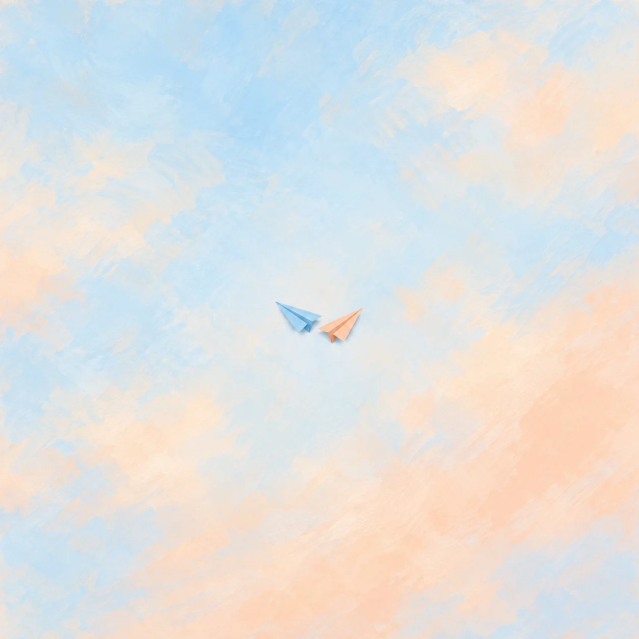 Two blank folded paper planes, one sky blue and one apricot, pointing in different directions on a pale blue and apricot background.