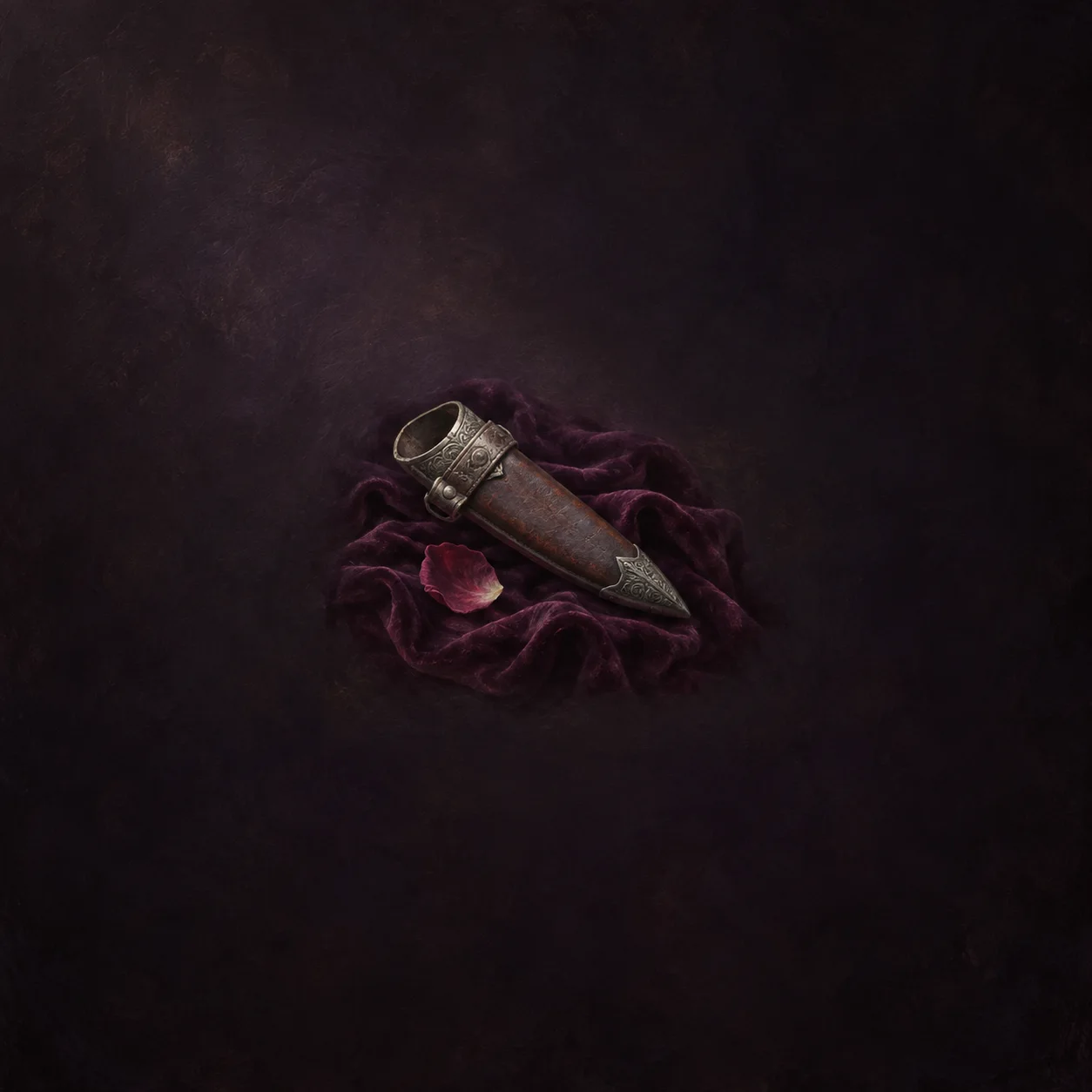 An empty decorated sheath rests on plum-coloured fabric beside a single pink rose petal.