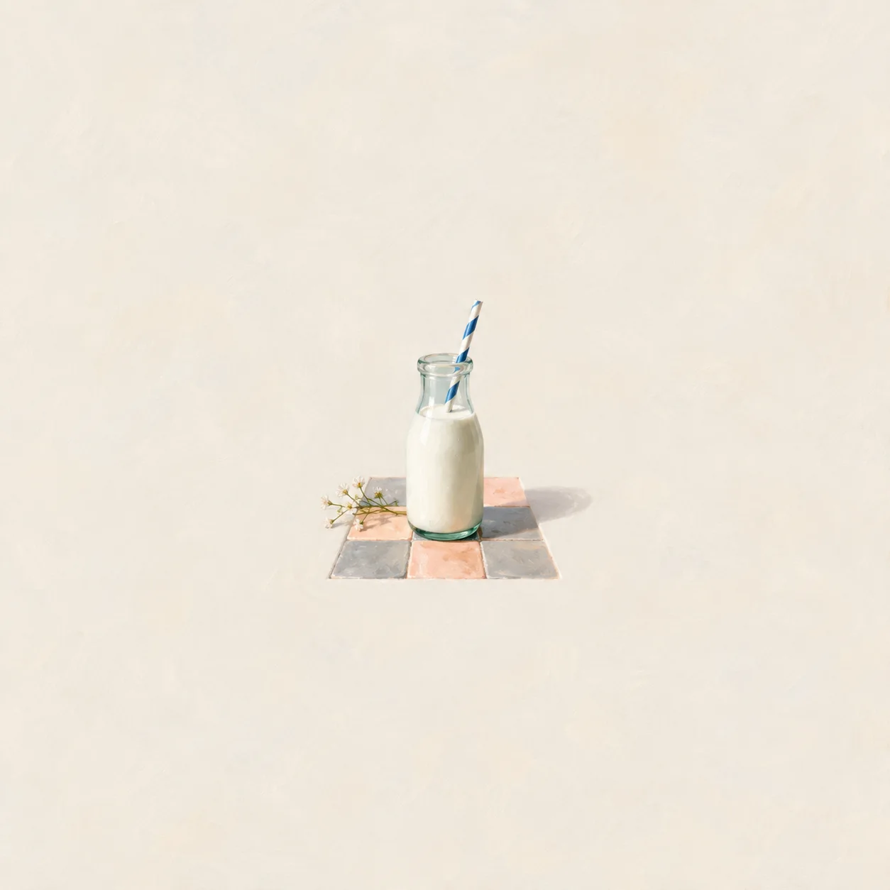 A glass milk bottle with a striped straw on a peach and grey tiled surface.