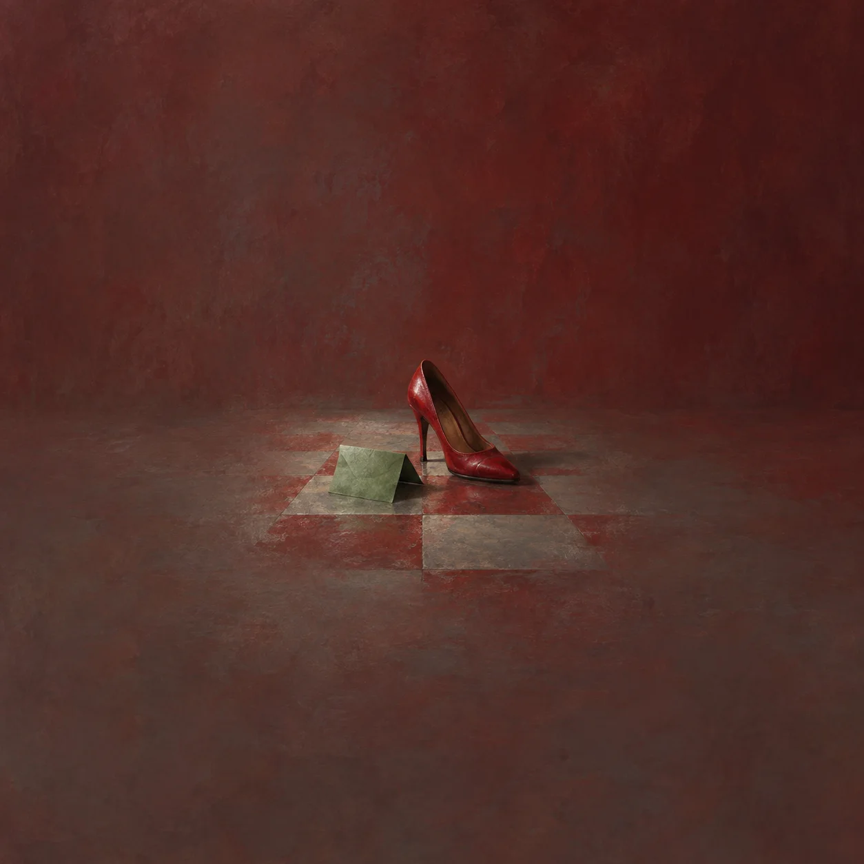 Painterly red high-heeled shoe beside folded pale green paper on a tiled floor.