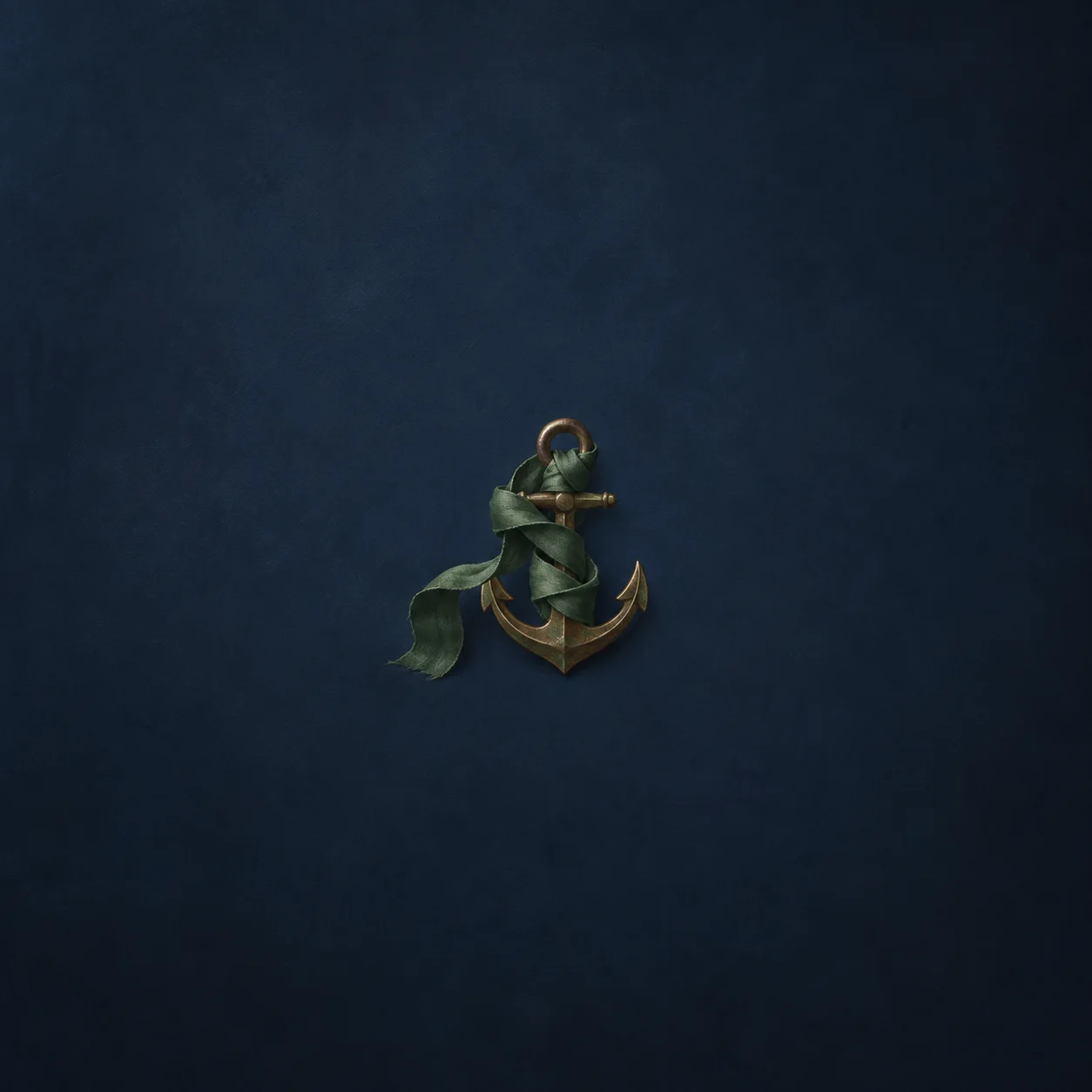 A green ribbon wrapped around a small bronze anchor against a navy background.