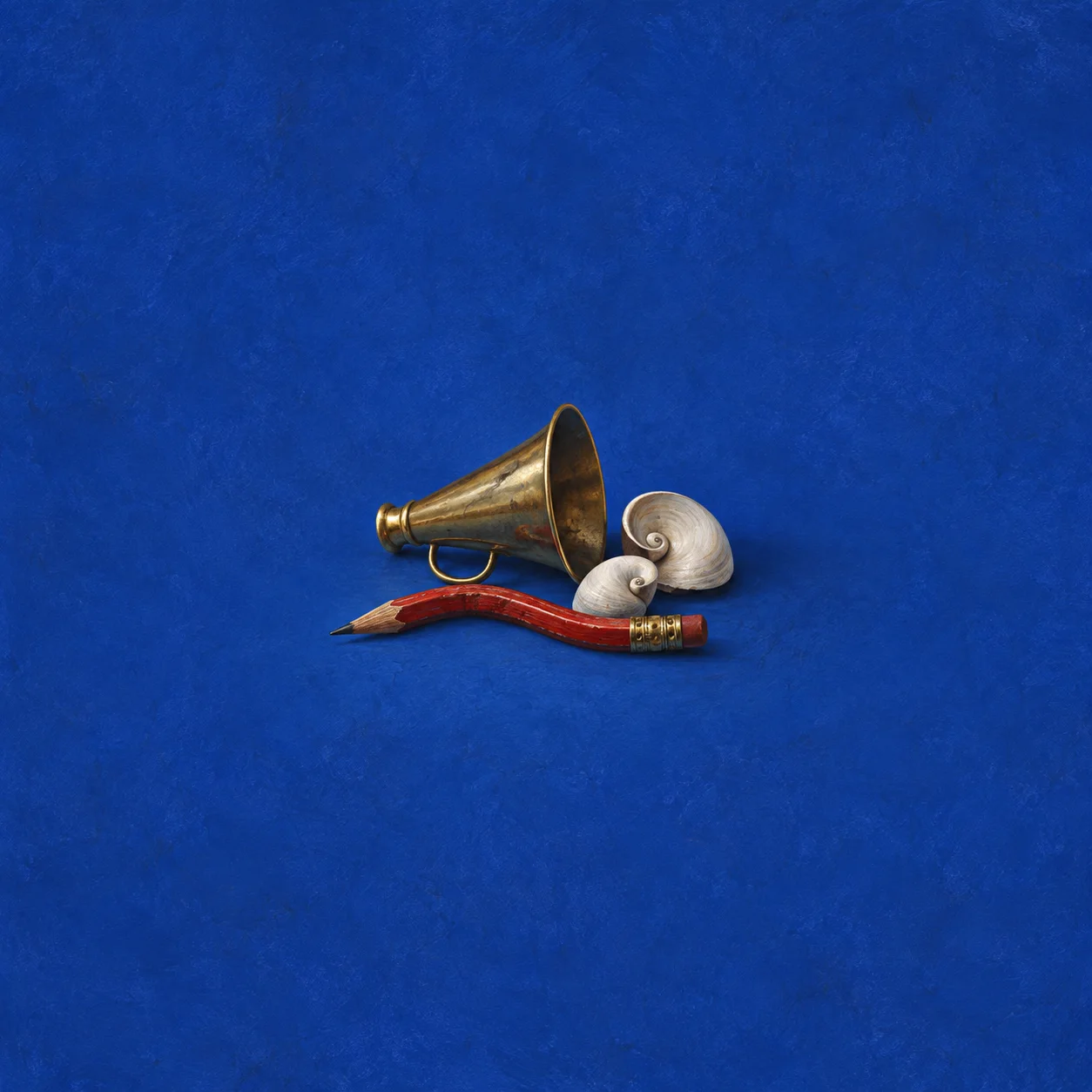 A small brass horn, a curved red pencil and two pale seashells on a cobalt blue surface.