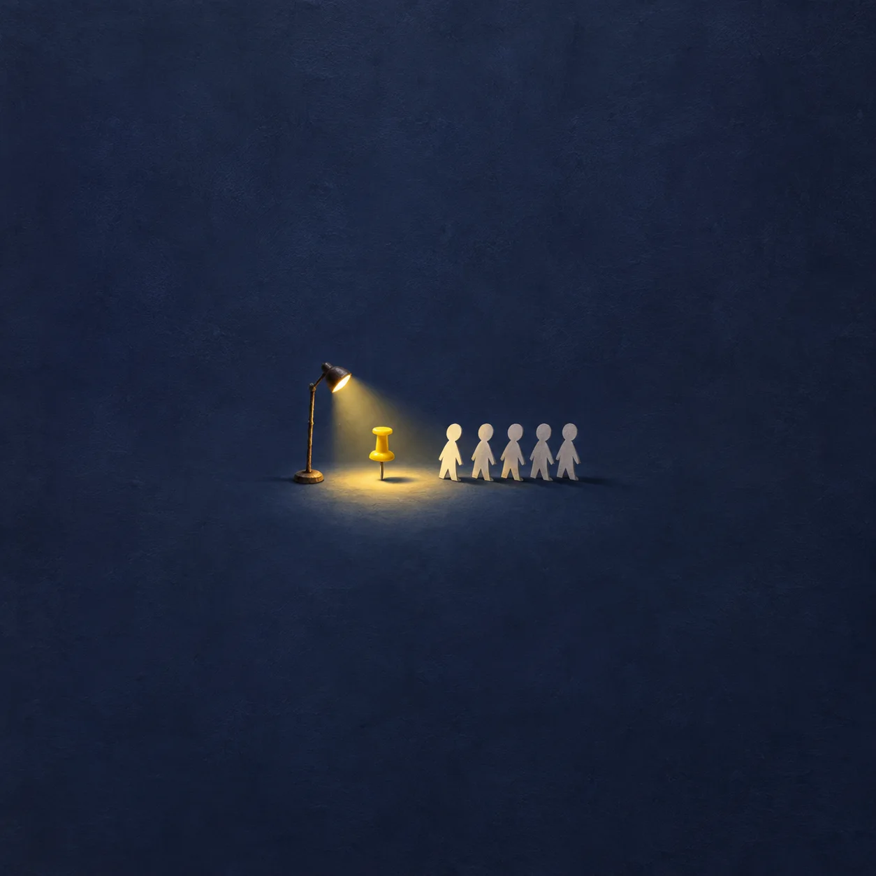 A small spotlight illuminates a yellow drawing pin beside a row of paper figures against dark blue.